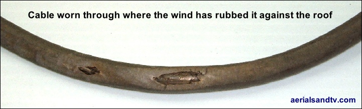 Cable worn through where the wind has rubbed it against the roof 721W L5